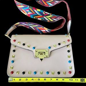 Pink Purse with color studs.  Leather. Unlined. Gold details. Like new.